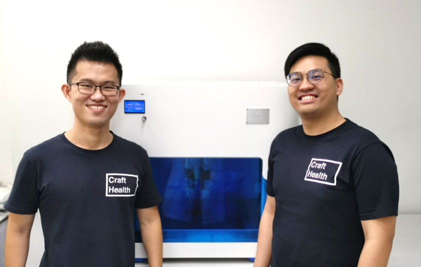 Left to Right: Co-founders Dr Seng Han LIM (COO of Craft Health) and Dr Wei Jiang GOH (CEO of Craft Health) posing with CraftMake™, an in-house developed 3D printer for nutraceuticals and pharmaceuticals.