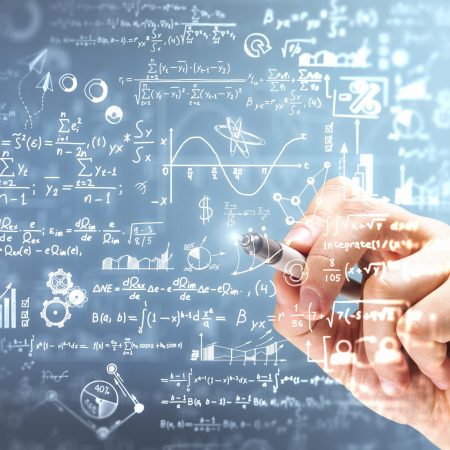 Male,Hand,Writing,Mathematical,Formulas,On,Blurry,Background.,Science,And
